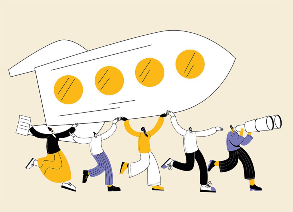 persone che alzano in alto un razzo in team